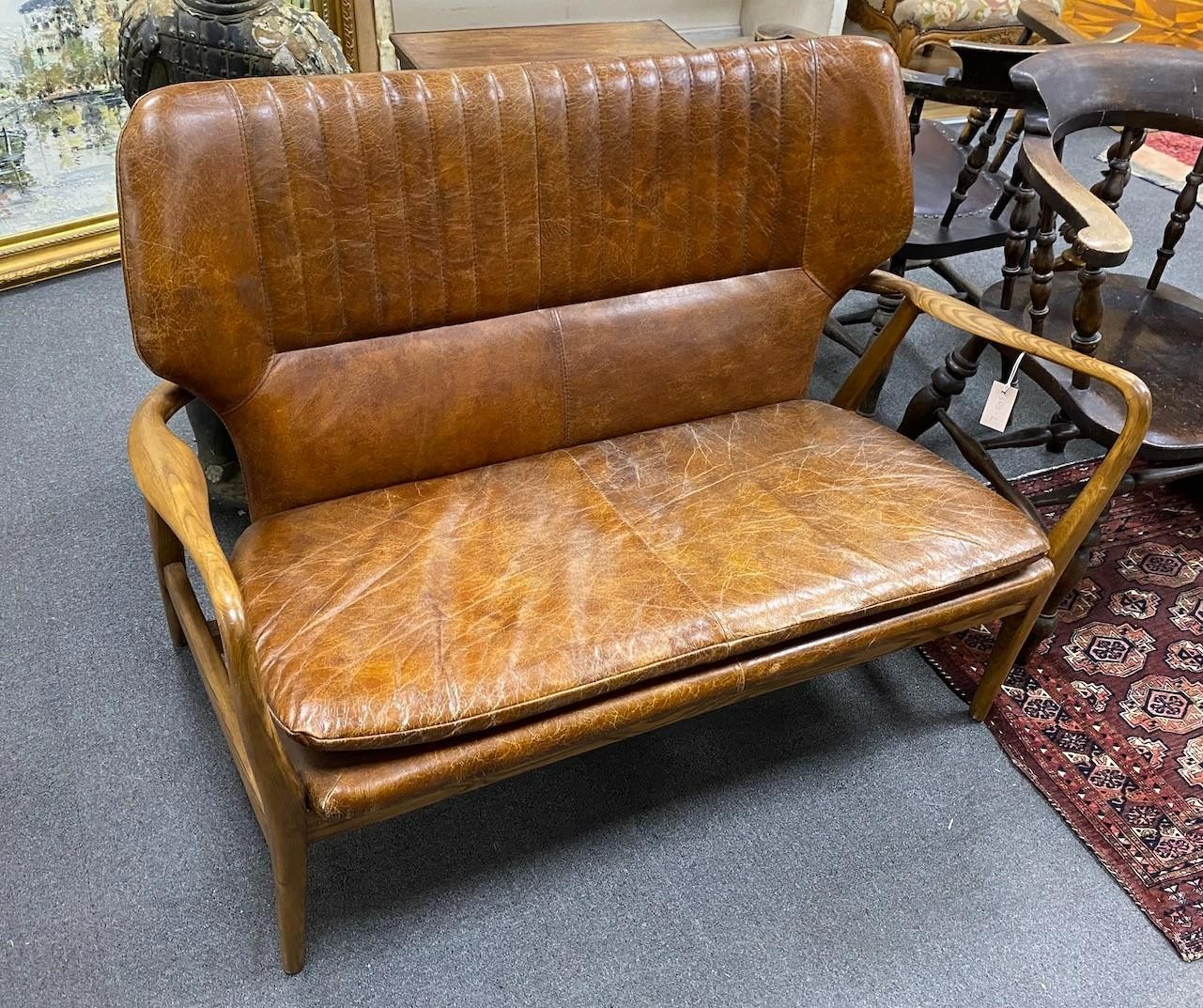 A Laura Ashley Whitworth oak and leather sofa, length 121cm, width 60cm, height 87cm